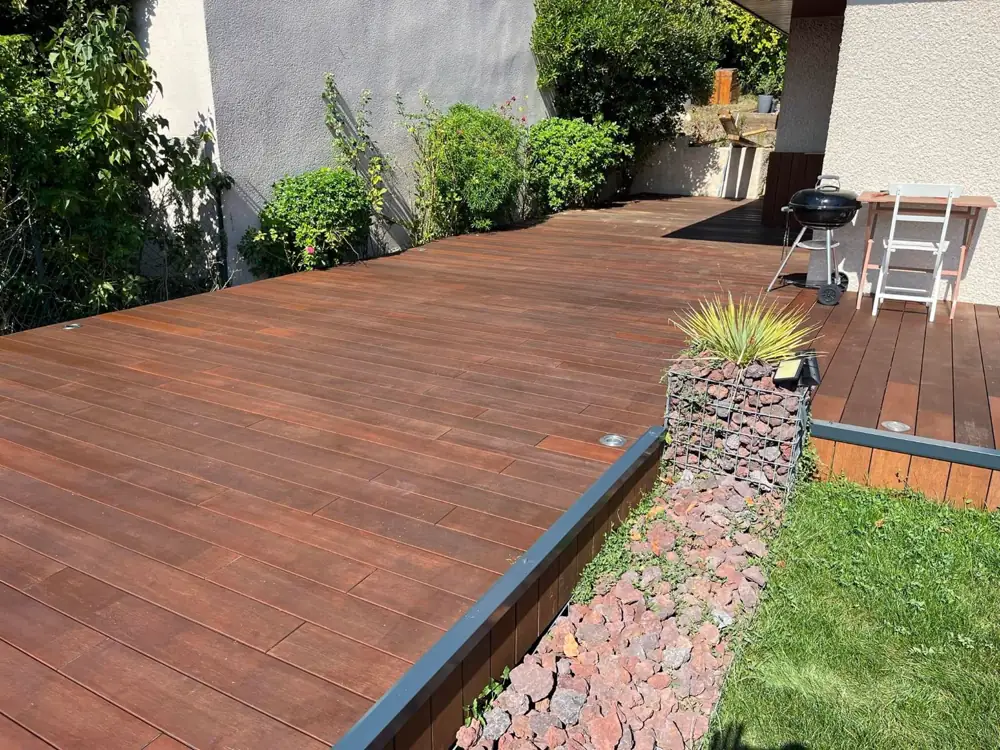 Terrasse en bois exotique avec muret en gabion et jardin